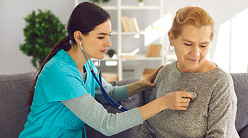 staff checking a patient with stethoscope