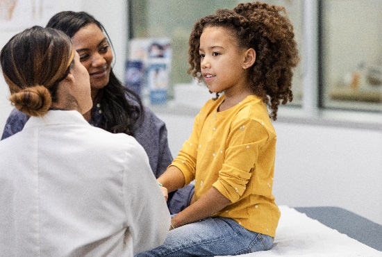 Physician discusses with child and parent